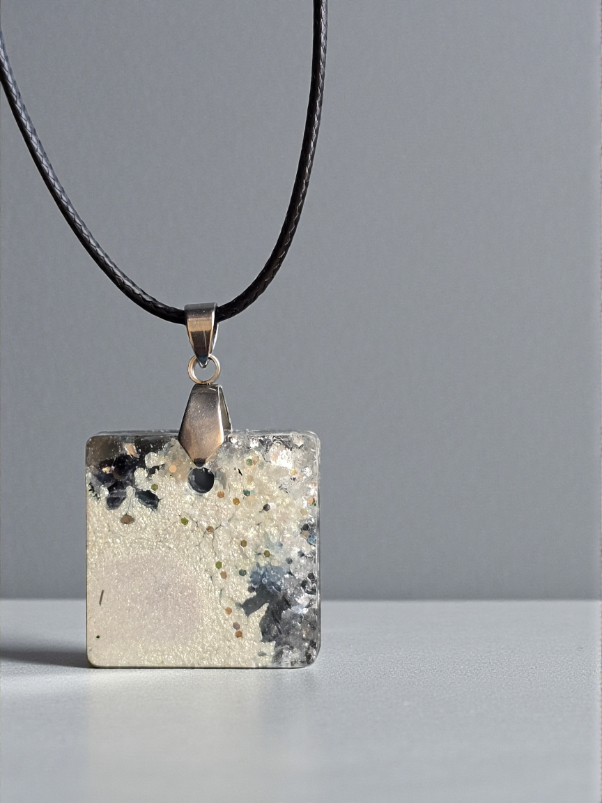 Pendant with a dash of sparkle silver, white and a glimpse of lilac on a black faux cord