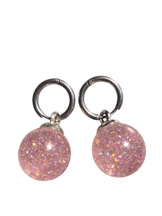 Earrings dangling huggie style pink transparent sparkling balls with a silver setting